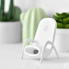 White wireless charging stand holding a smartphone in vertical position on a desk, with a sleek design, ideal for fast charging Qi-enabled devices like iPhone and Samsung